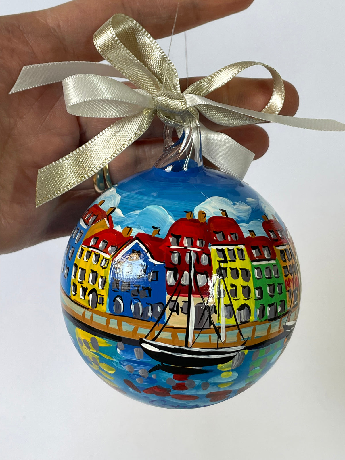Hand-painted Copenhagen glass ornament with Nyhavn harbour, sailboats and colourful buildings reflected in water, gold ribbon – FerrariSoniArt